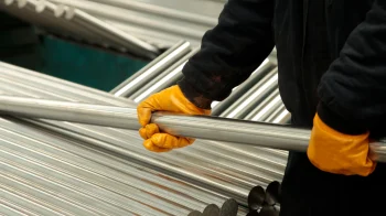 new-steel-pipes-a-worker-at-the-factory-2023-11-27-05-06-10-utc
